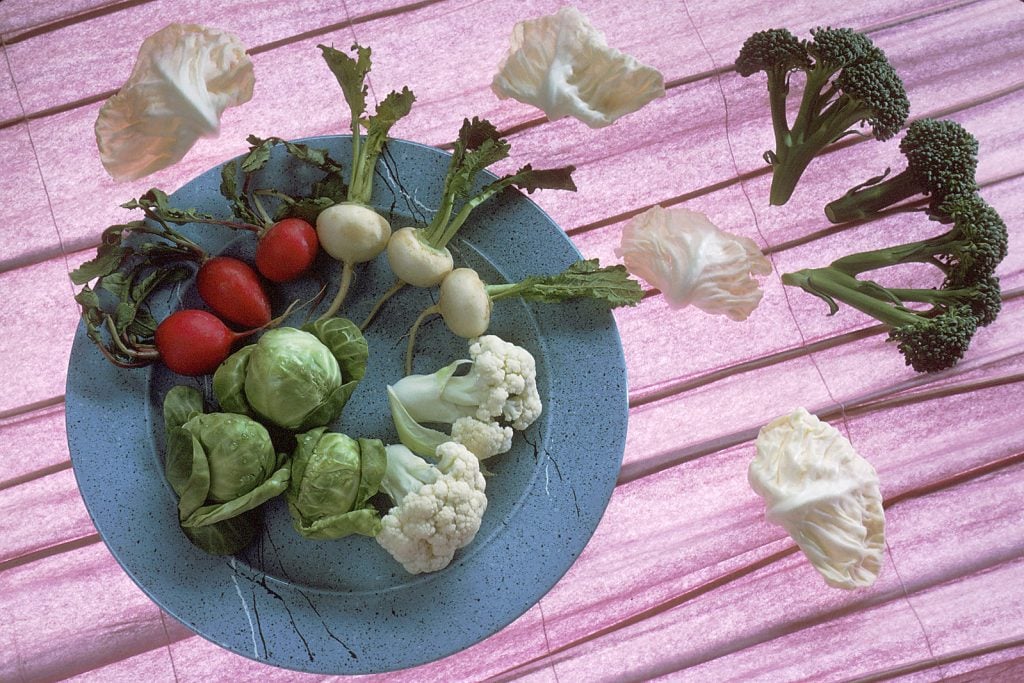 A plate full of cruciferous vegetables, including radishes.